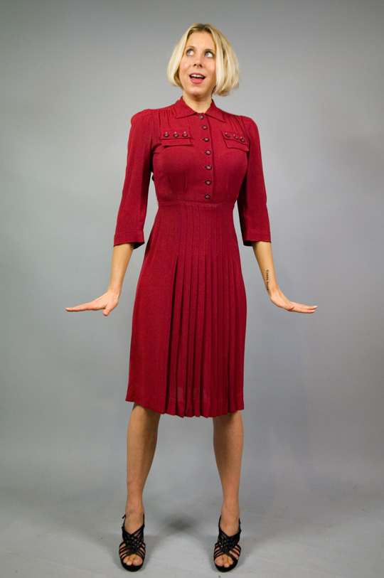 1940s red military dress model wearing a 1940s red military dress