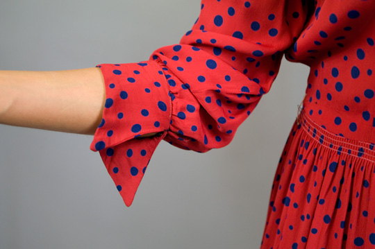 1940s Red Polka Dot Rayon Dress Sleeve the sleeve and cuffs of a 1940s red polka dot rayon dress