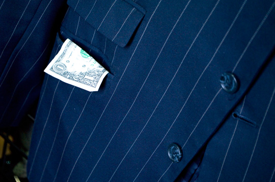 Thrift Store Finds Money a dollar bill hanging out of a men's blazer pocket